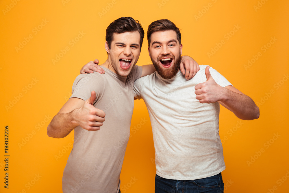Portrait of a two happy young men showing thumbs up Portrait of a two happy young men showing thumbs up