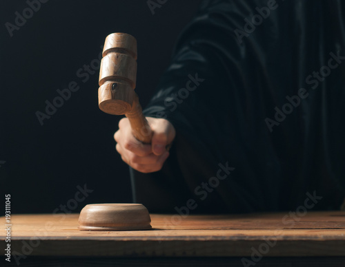 3006919 Hand banging gavel on dark background, the judge makes a verdict,