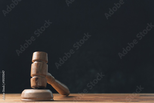 Mallet on a dark background, judges wooden gavel,