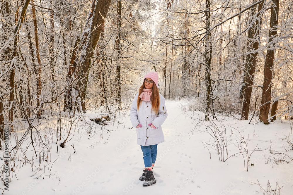 girl in winter forest with snow-covered branches of trees. fairy beauty.