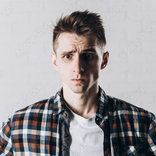 Handsome emotional man isolated over gray background