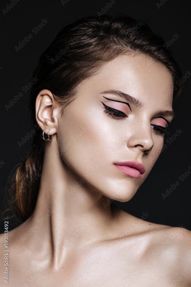 beautiful model woman with natural make-up and brunette hair studio fashion shot on black background