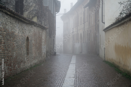 The mistic street in the city, foggy day in Italy