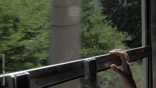 Girl holds onto the window in the train - Georgia photo