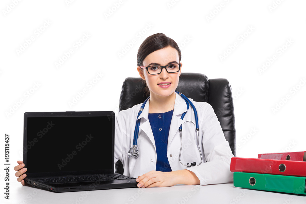 Young woman doctor with stethoscope sitting on the desk at medical office in white uniform on white background Young woman doctor with stethoscope sitting on the desk at medical office in white uniform on white background