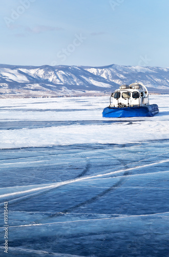 Bilde på lerret Boat on an air cushion Khivus transports tourists on the ice of the frozen Lake