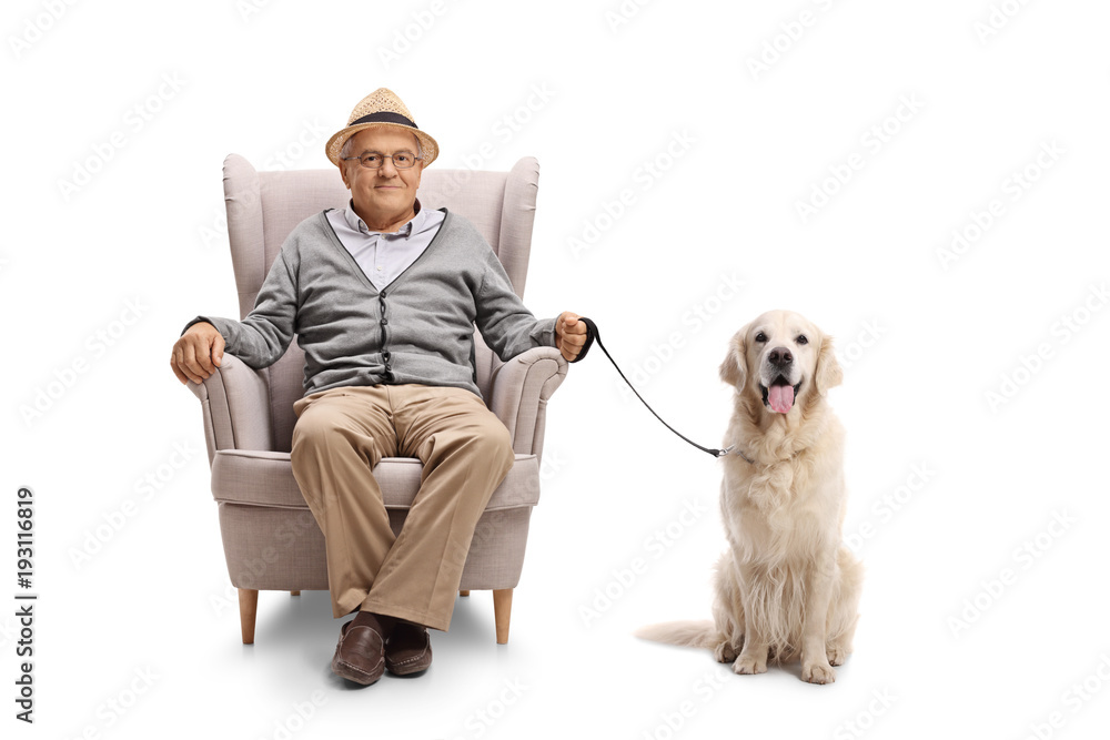 Elderly man with a labrador retriever dog sitting in an armchair Elderly man with a labrador retriever dog sitting in an armchair