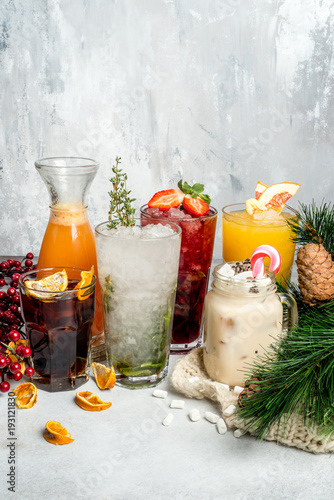 Several cocktails in glasses shot against the background photo