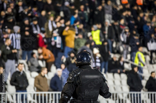 The police at the stadium event secure a safe match against the hooligans photo