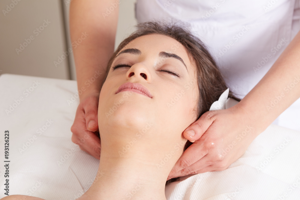 Female Enjoying Relaxing face Massage In Cosmetology Spa Center Female Enjoying Relaxing face Massage In Cosmetology Spa Center