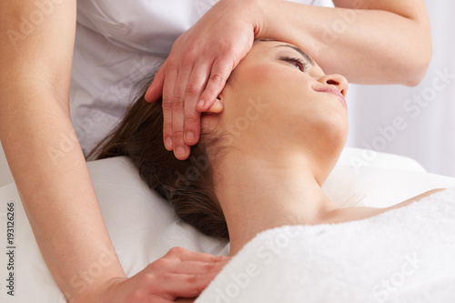 Female Enjoying Relaxing face Massage In Cosmetology Spa Center