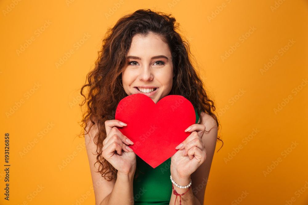 Beautiful young lady holding heart looking camera. Beautiful young lady holding heart looking camera.
