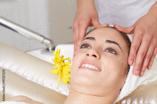 Female Enjoying Relaxing face Massage In Cosmetology Spa Center