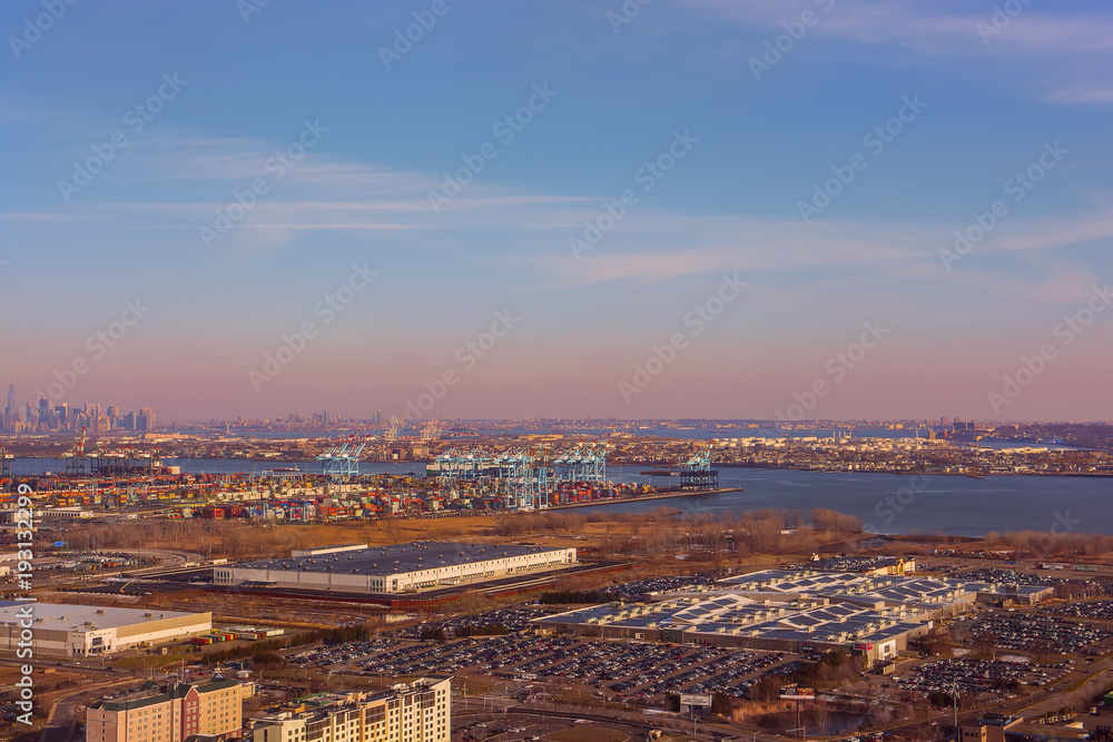 A bird's eye view of the suburb of New York and New York on the horizon.  View from the height of the suburbs of New York and New York on the horizon. View of the cargo port.
