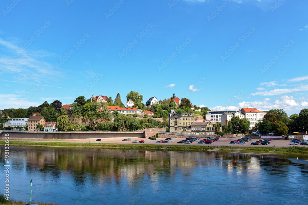 A view of the picturesque historical buildings along the Elbe River in Meissen, Germany. A view of the picturesque historical buildings along the Elbe River in Meissen, Germany.