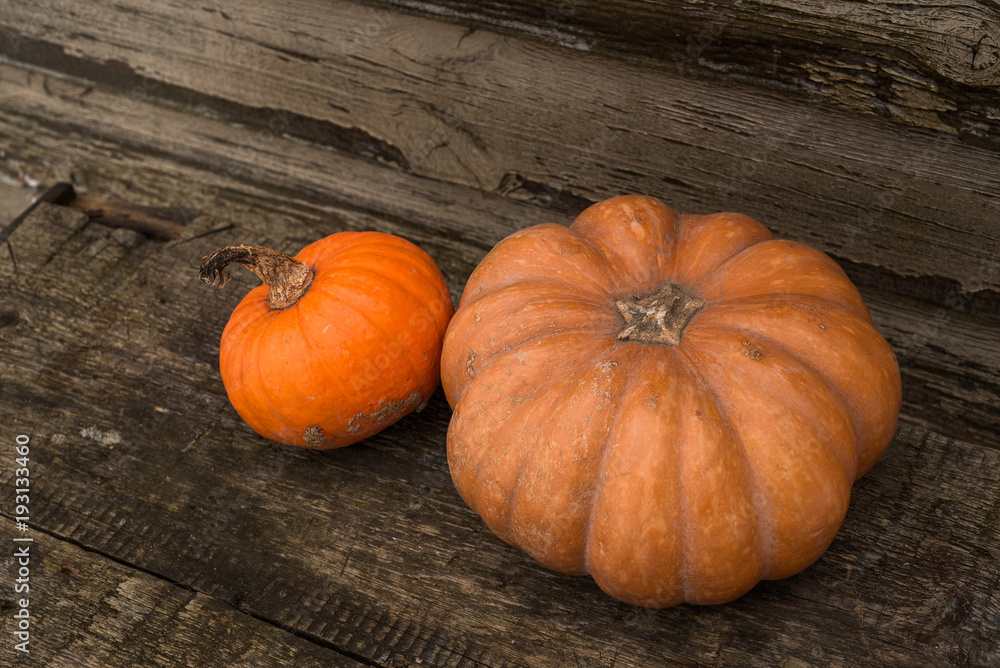 Orange autumn pumpkins on the old rustic table with vintage film colours background Orange autumn pumpkins on the old rustic table with vintage film colours background
