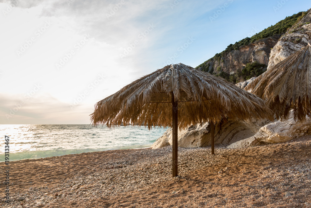 scenic beach sunset sea view on a sea and palm leaf umbrella scenic beach sunset sea view on a sea and palm leaf umbrella