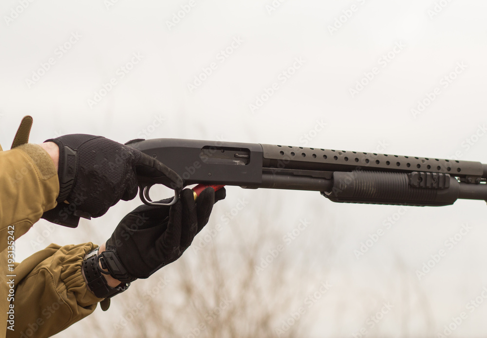 Close up picture of pump action shotgun reloading Close up picture of pump action shotgun reloading