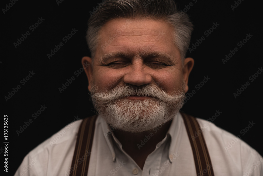 smiling bearded senior man isolated on black smiling bearded senior man isolated on black