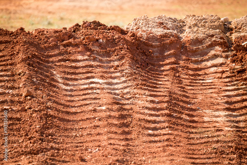 Traces from the car on the red clay soil © schankz