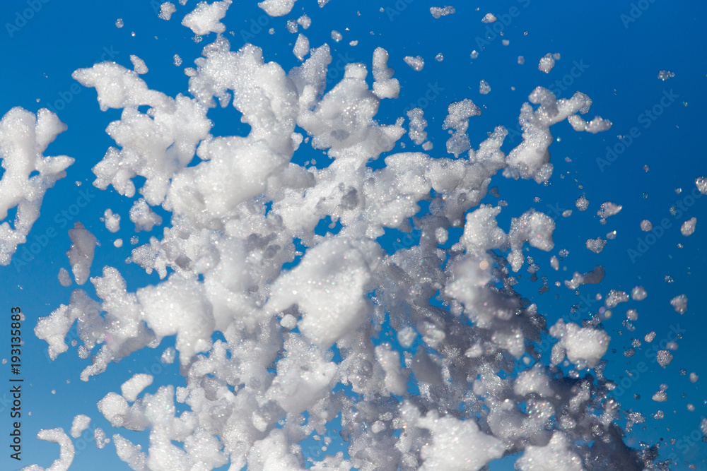 Fototapeta premium White foam against the blue sky as background