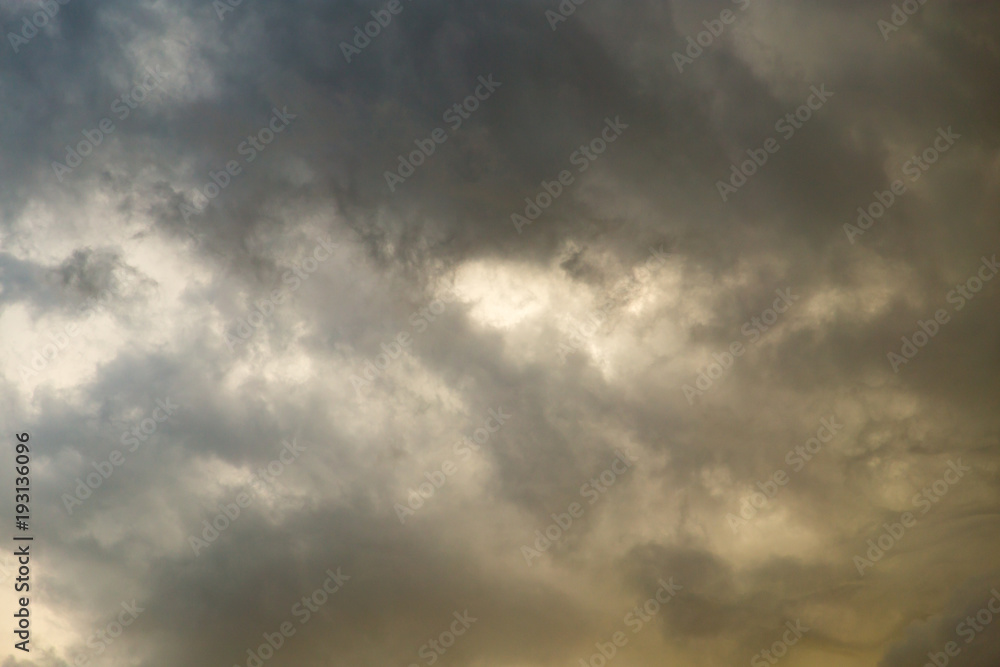 Storm clouds in the sky at sunset as background Storm clouds in the sky at sunset as background