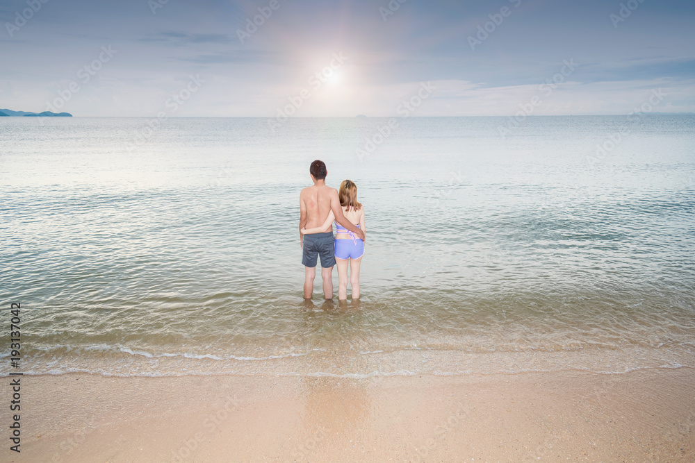 Back view Young Couple romantic travel honeymoon on Beach Back view Young Couple romantic travel honeymoon on Beach