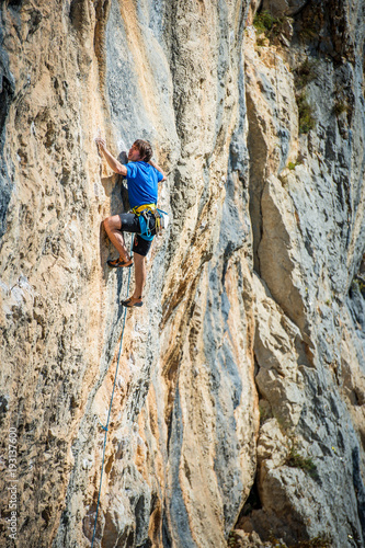 Young man climbing extreme hard route on limestone rocks