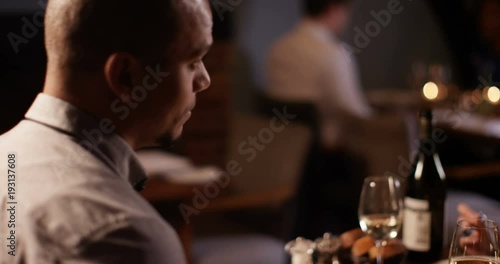 Wallpaper Mural 4K Happy mixed ethnicity couple on a date in restaurant chatting as they enjoy their meal Torontodigital.ca