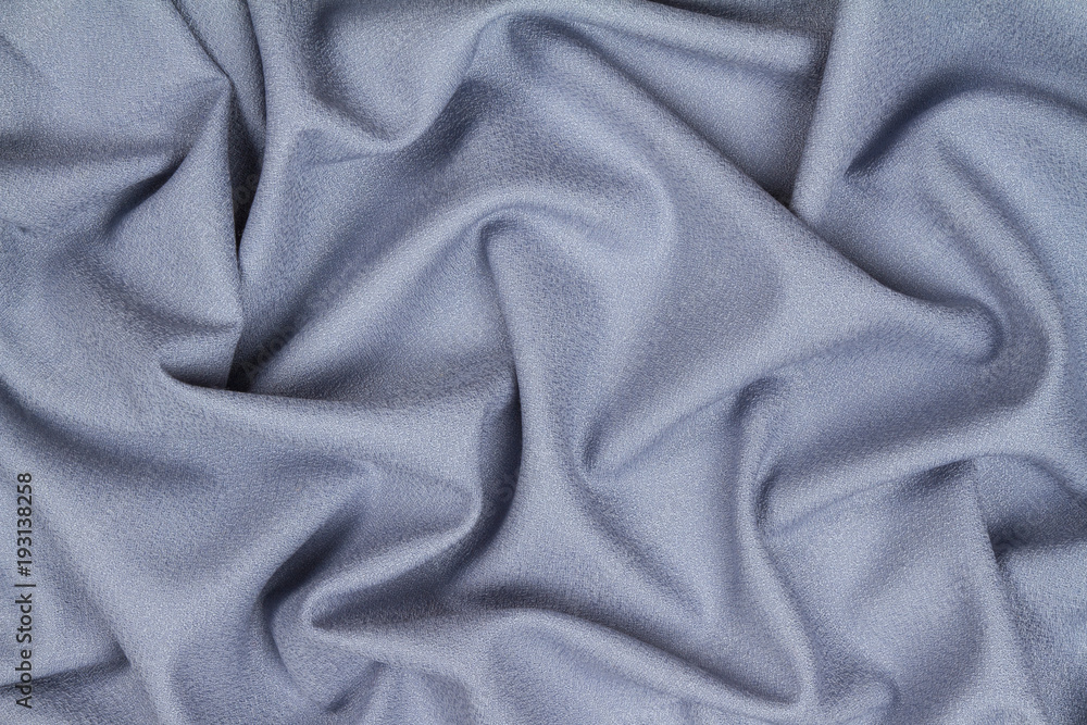 Fototapeta premium Blue woolen crumpled wrinkled fabric with waves, background crumpled tissue.