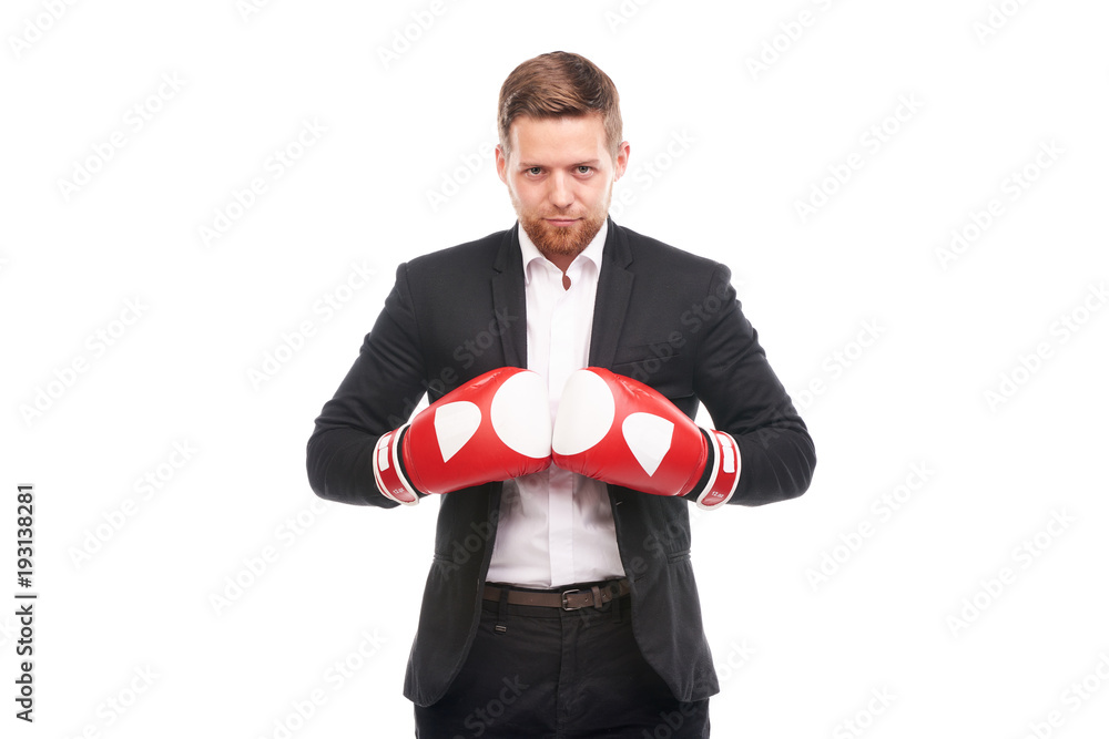 Studio portrait of young businessman in white shirt and suit wearing red boxing gloves on white background Studio portrait of young businessman in white shirt and suit wearing red boxing gloves on white background