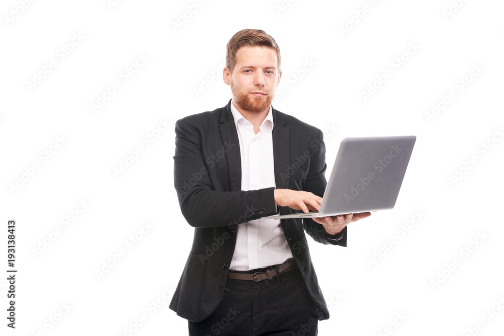 Studio portrait of young manager in suit holding open laptop Studio portrait of young manager in suit holding open laptop