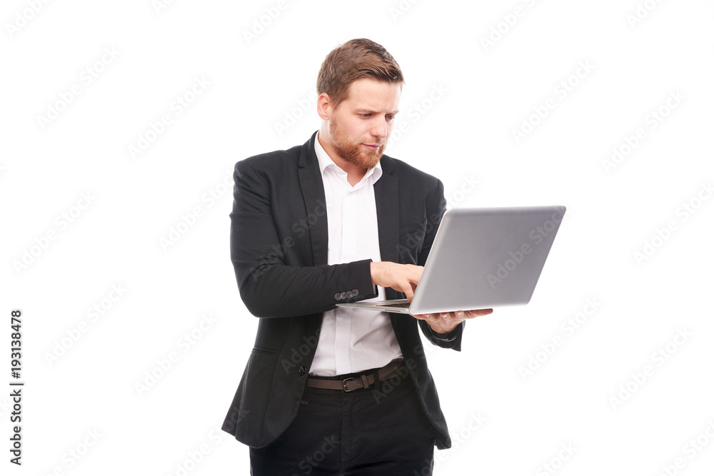 Studio portrait of young manager in suit holding open laptop Studio portrait of young manager in suit holding open laptop