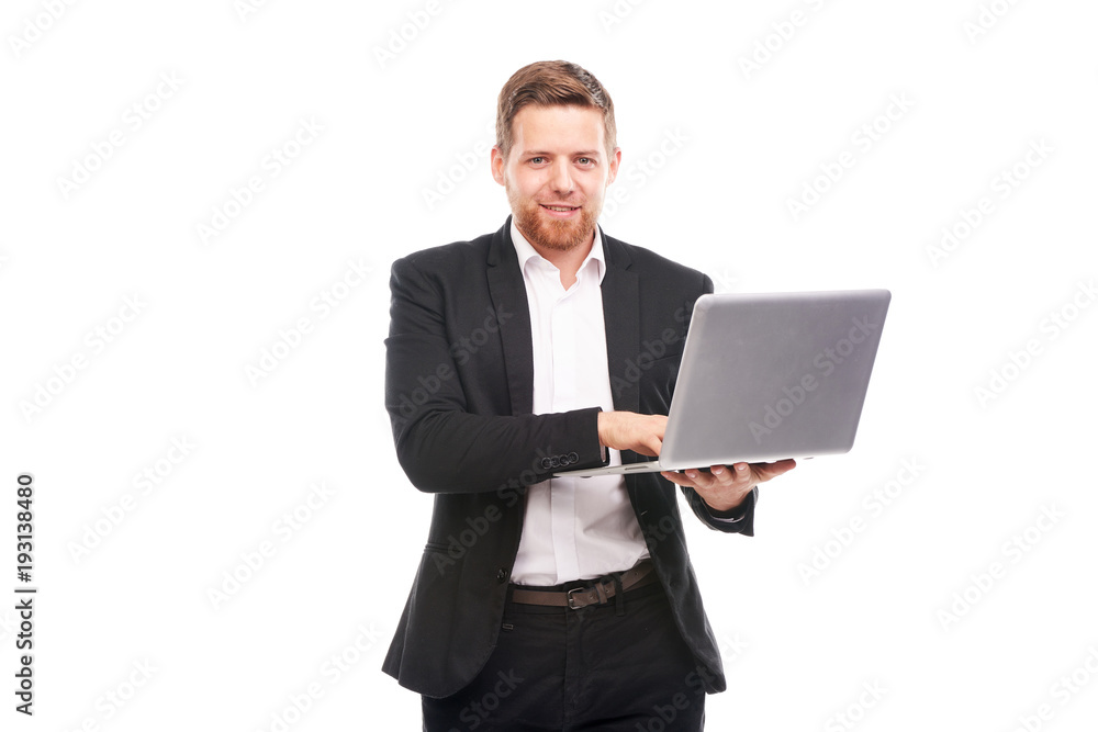 Studio portrait of young manager in suit holding open laptop Studio portrait of young manager in suit holding open laptop