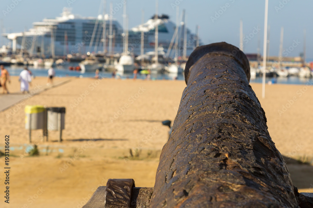 Old cannon on the promenade near the harbor in Palamos