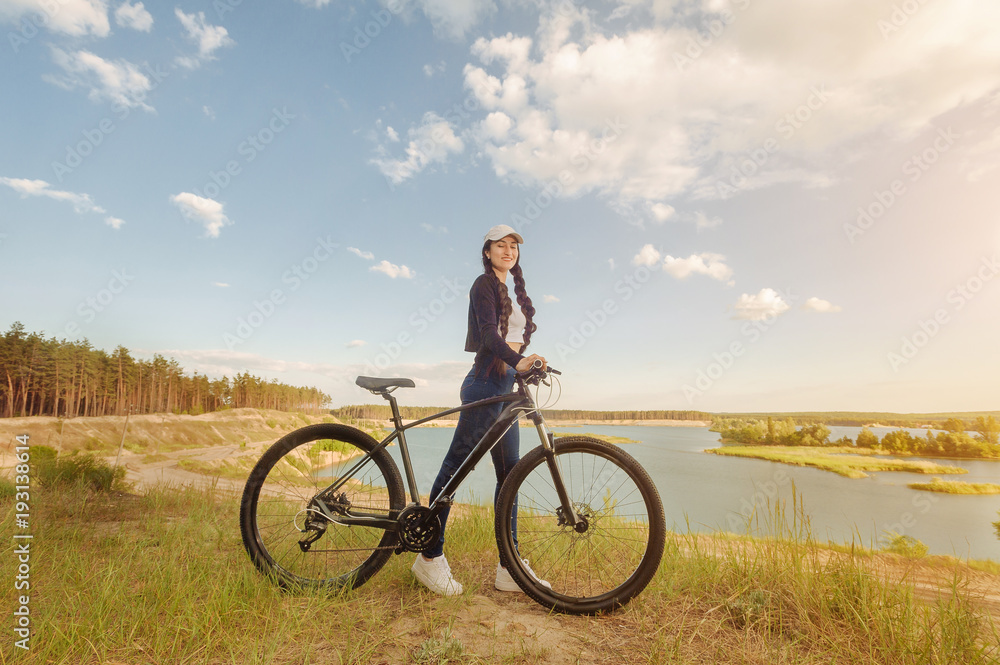 Vacation time. Hipster woman traveling with bicycle on the forest relax time and holiday, color sport style selective and soft focus Vacation time. Hipster woman traveling with bicycle on the forest relax time and holiday, color sport style selective and soft focus