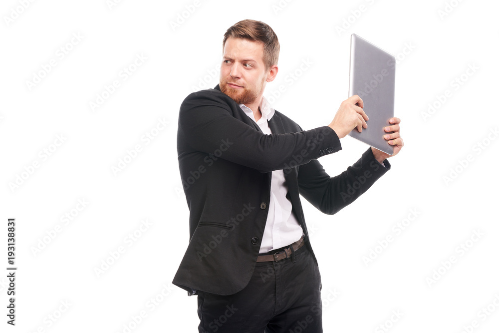 Studio portrait of young manager in suit holding laptop on white background Studio portrait of young manager in suit holding laptop on white background