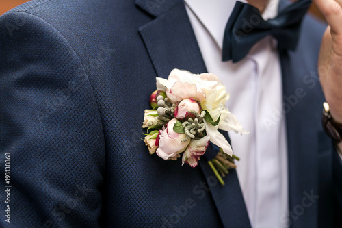 white rose boutonniere on groom's suit