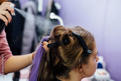 girl in the beauty salon is weaved with braids. braided pigtails. photo