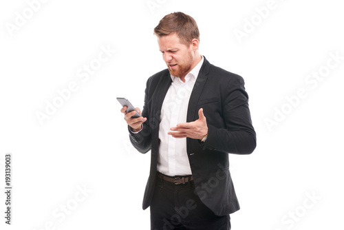 Portrait of young businessman with mobile phone on white background