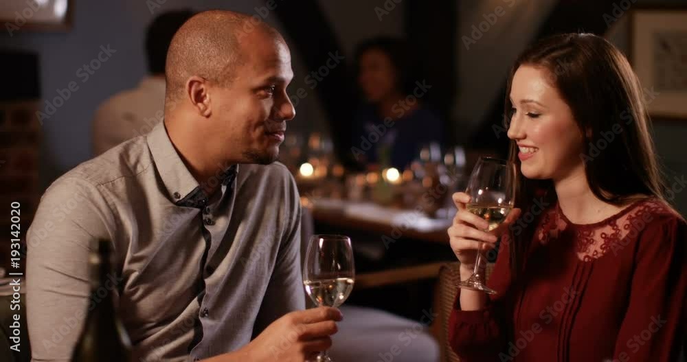4K Attractive young couple on a date, drinking wine and enjoying each other's company 4K Attractive young couple on a date, drinking wine and enjoying each other's company