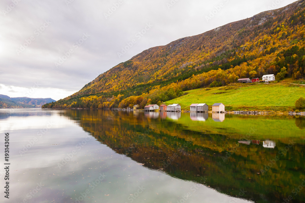 autumn rural landscape with houses near river, Norway
