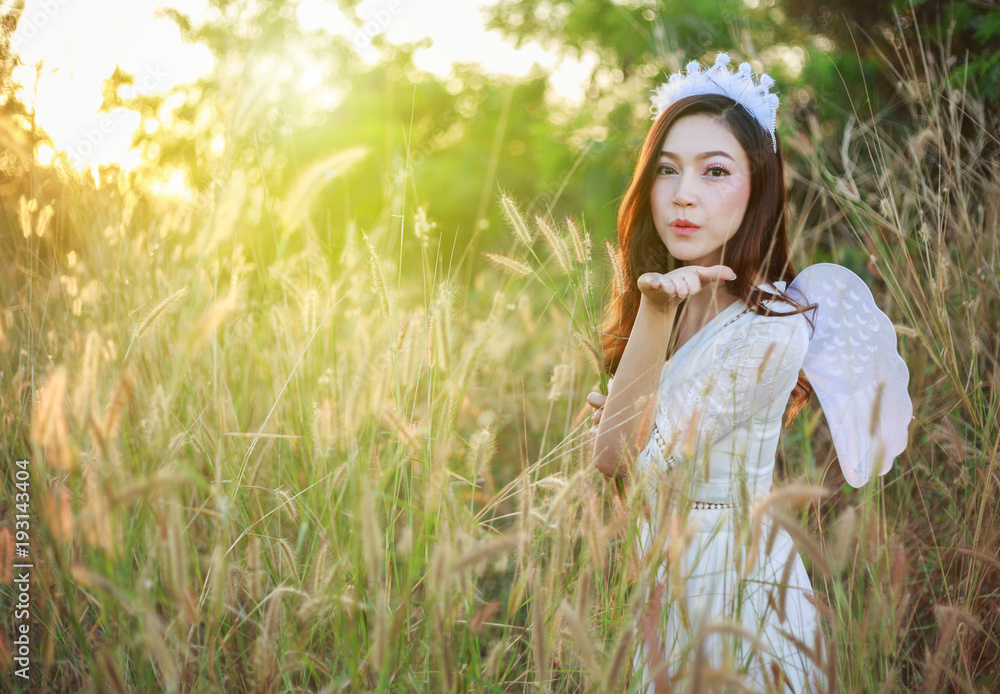 angel woman in a grass field with sunlight angel woman in a grass field with sunlight