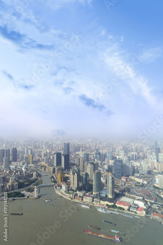aerial view of Shanghai city skyline and modern skyscraper and Historical architecture on the bund of Shanghai in misty sky pollution haze, in Shanghai, China. © lukyeee_nuttawut