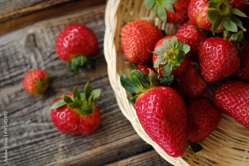 Fresh juicy strawberries in a wooden basket on the table