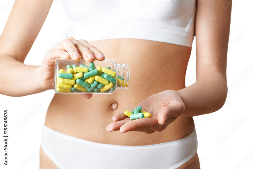 Close up Of Woman In Underwear Taking Generic Pills From Bottle Close up Of Woman In Underwear Taking Generic Pills From Bottle
