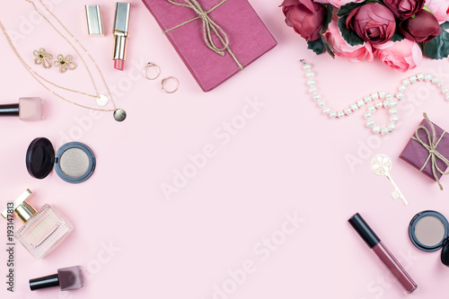 Beauty blog concept. Accessories, flowers, cosmetics and jewelry on pink background, copyspace. Womens Day concept