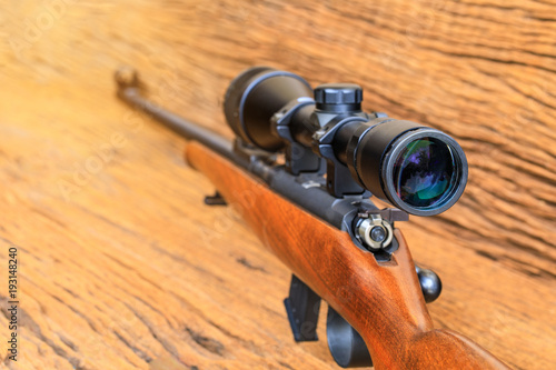 The riflescopes  on old wooden  background .