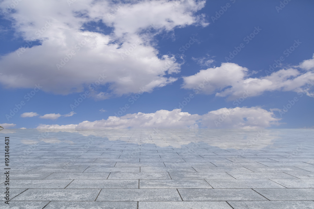 Asphalt pavements and square floor tiles under the blue sky and white clouds Asphalt pavements and square floor tiles under the blue sky and white clouds