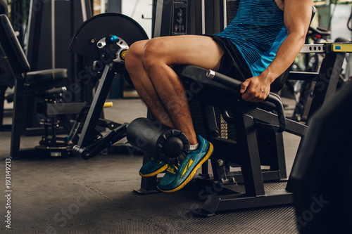 Closeup nice muscle runner legs with leg machine, Sport concept.